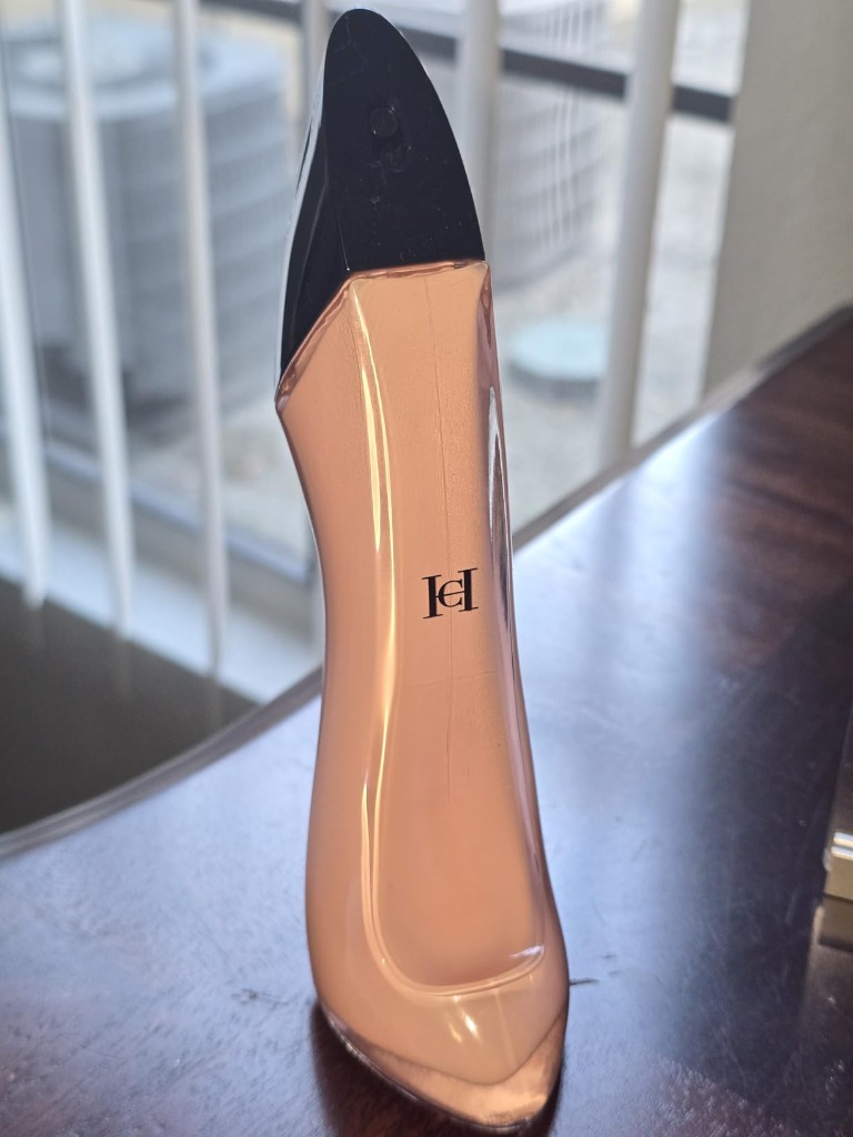 Close-up of Good Girl Blush front showing gold CH monogram emblem and pastel pink lacquer