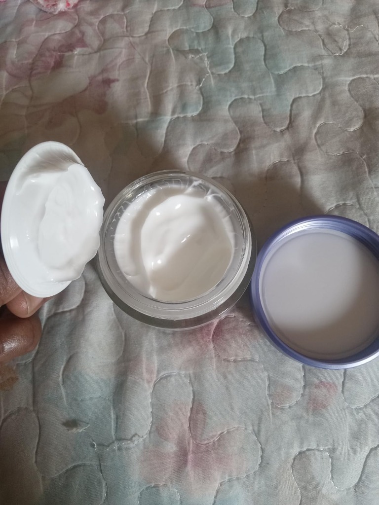 Open jar of L'Oreal Paris Collagen Moisture Filler showing rich whipped cream