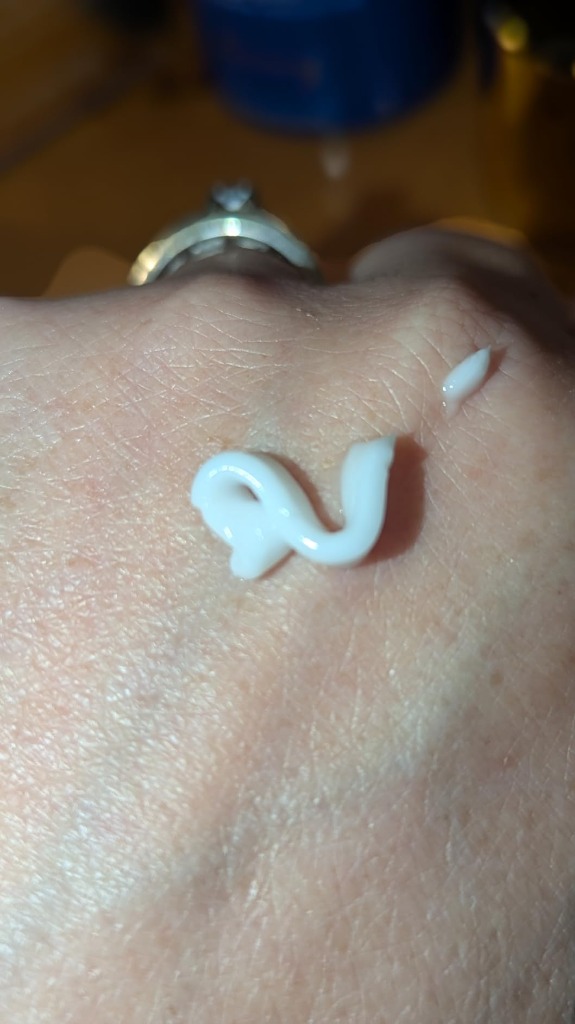 Close-up hand swatch of MARÉE cream showing smooth white whipped ribbon texture