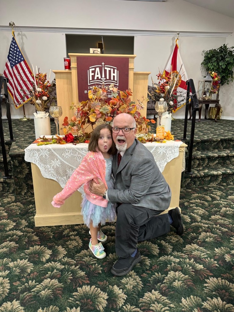 Little girl with grandpa at church in sparkly sequin jacket