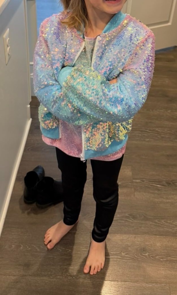Girl wearing pastel blue pink gradient sequin jacket