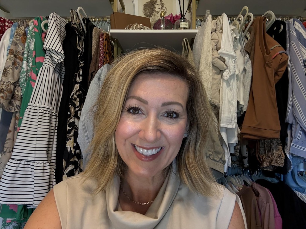 Radiant smiling woman in closet showing all-day foundation wear