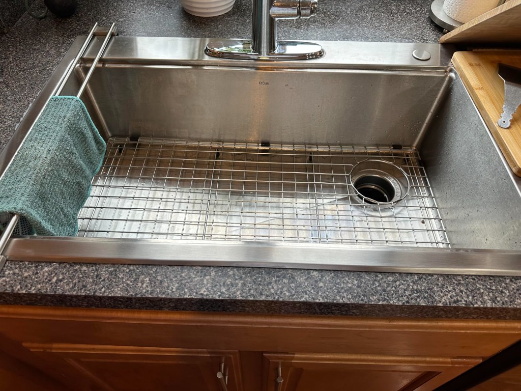 KRAUS Fairlane sink loaded with dish drying rack and bamboo cutting board accessories