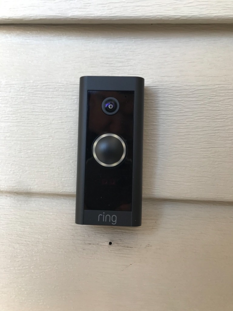 Ring Video Doorbell Wired mounted on vinyl siding exterior