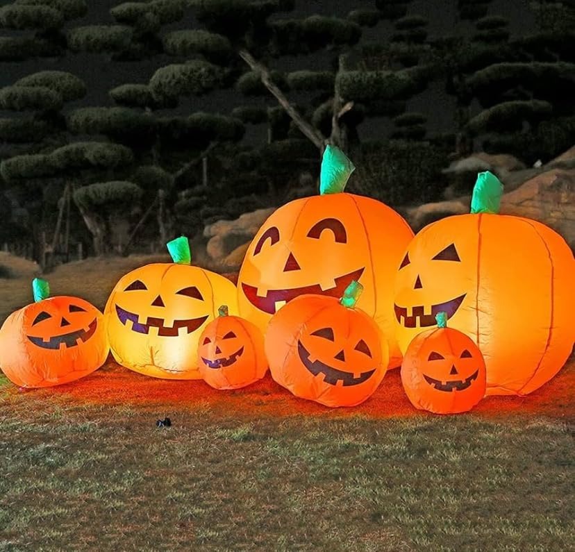 Tangkula 7.5 Ft Inflatable Pumpkin Patch glowing at night on lawn