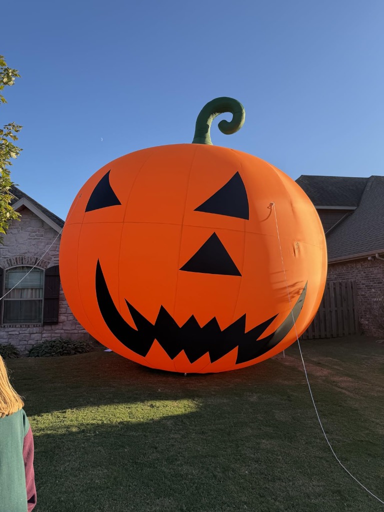 TKLoop Giant Pumpkin towering beside suburban house roofline