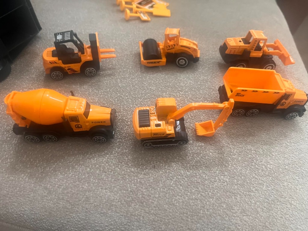 Six mini die-cast construction vehicles displayed